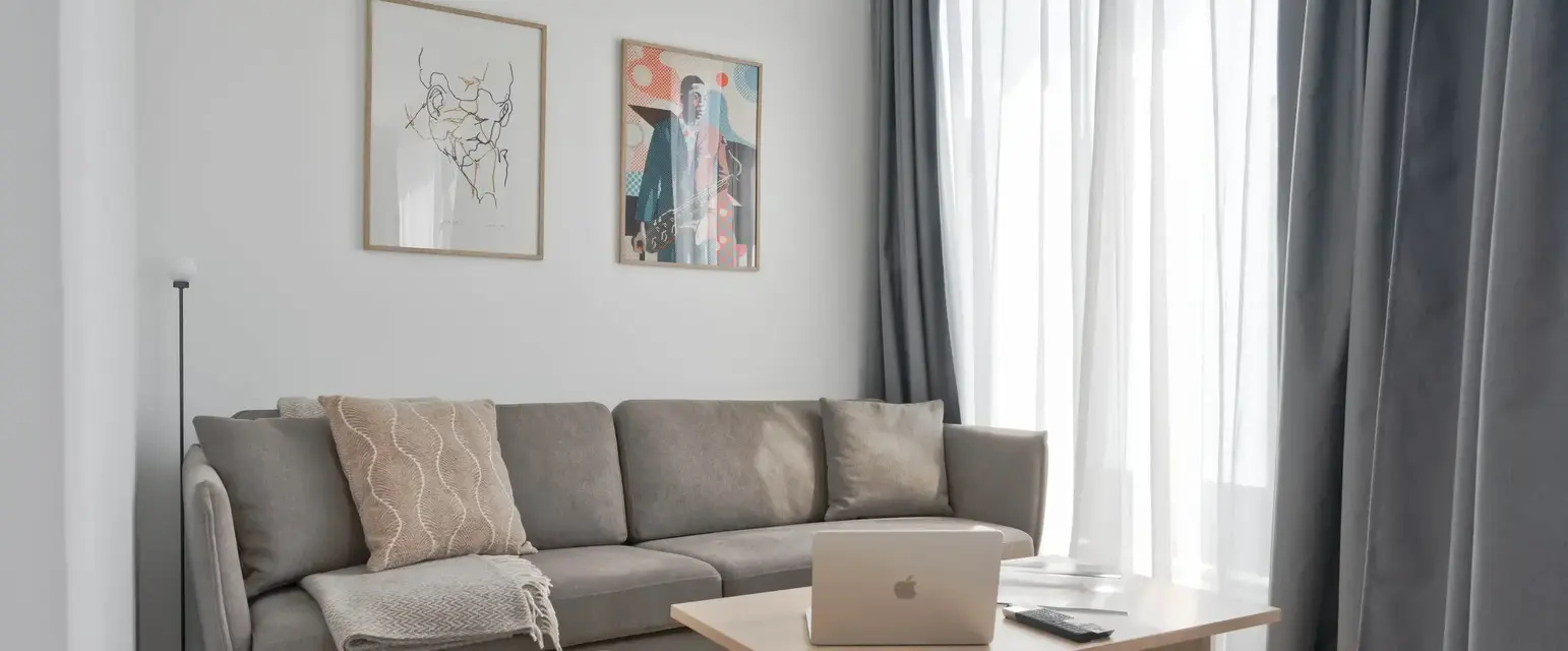 a couch with a laptop on a table in a room