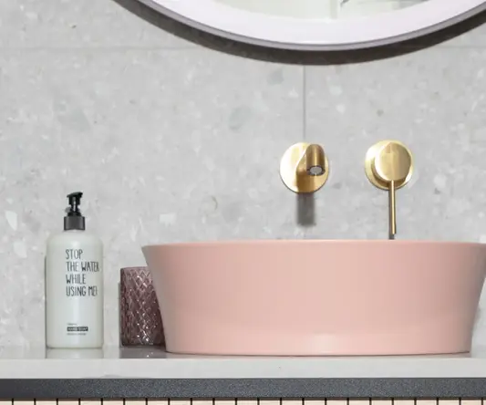 a pink sink on a counter top