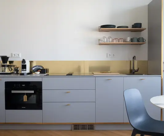 a kitchen with a chair and a table