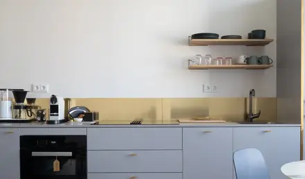 a kitchen with a chair and a table