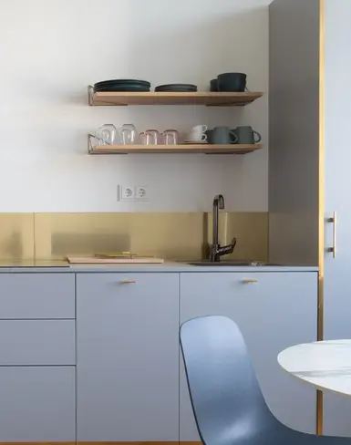 a kitchen with a chair and a table