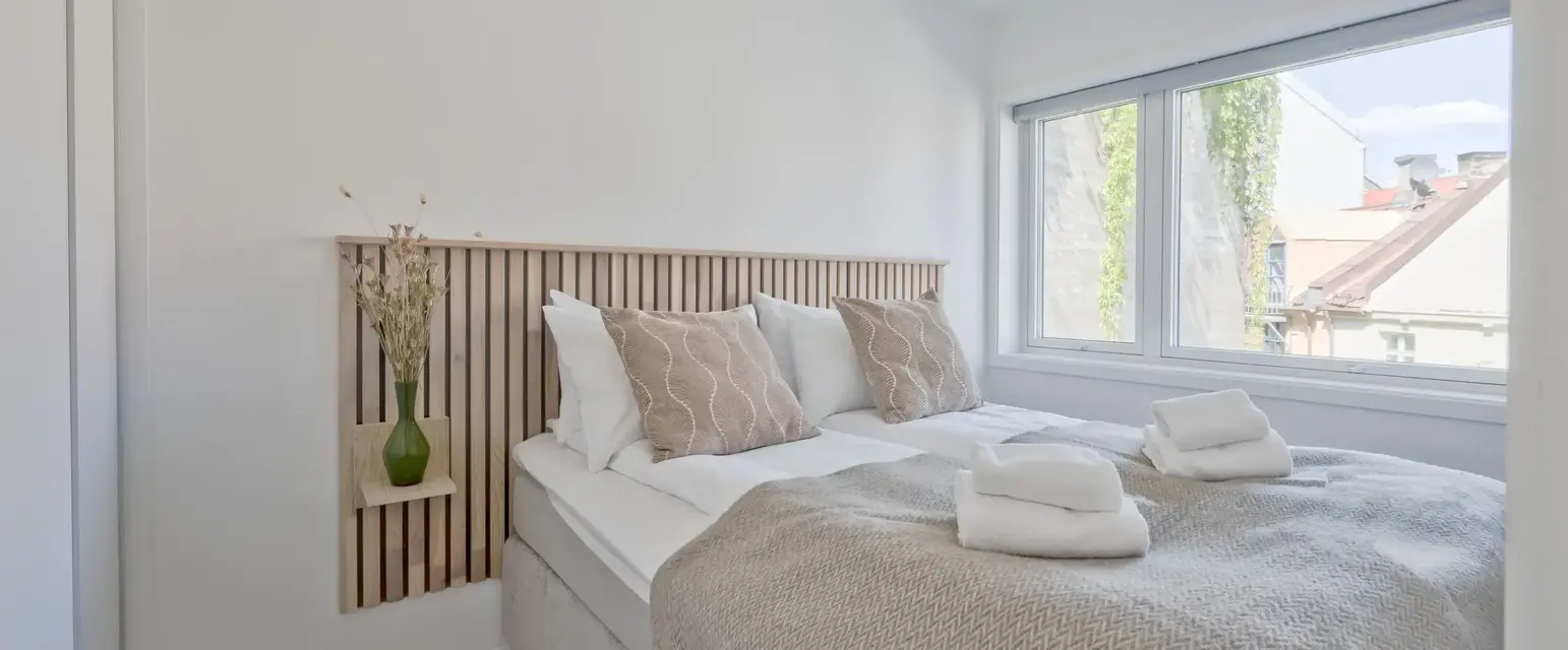 a bed with pillows and towels on it