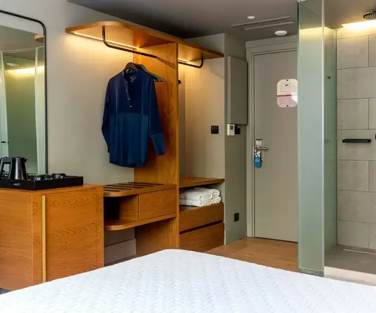 a room with a bed and a mirror