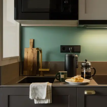 a kitchen with a microwave and a plate of food