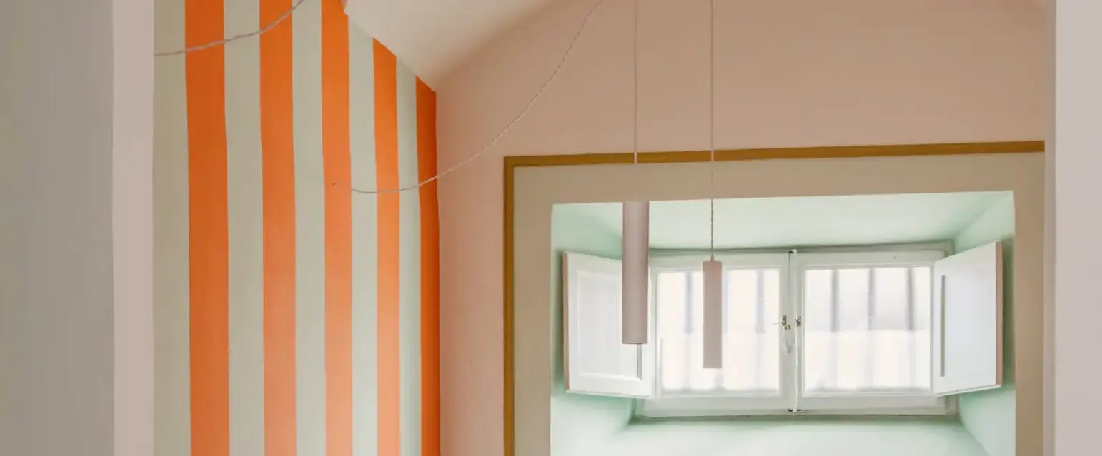 a room with white chairs and tables