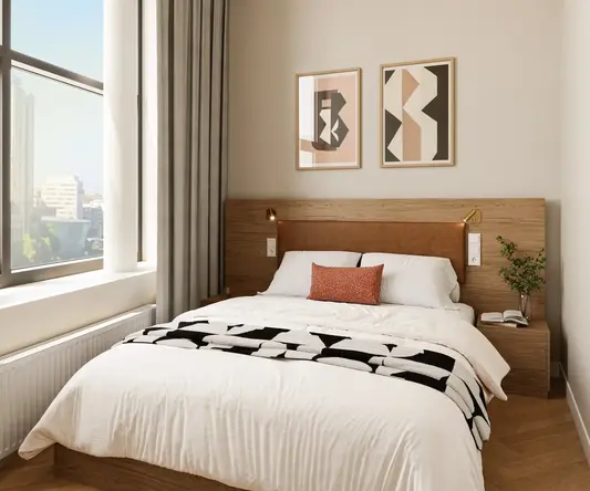 a bed with a wood headboard and a lamp