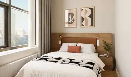 a bed with a wood headboard and a lamp