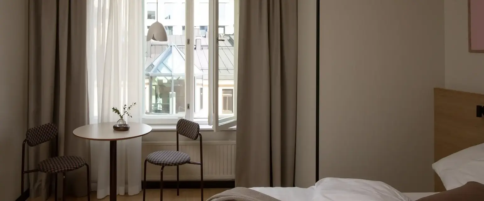 a room with a bed and chairs and a table