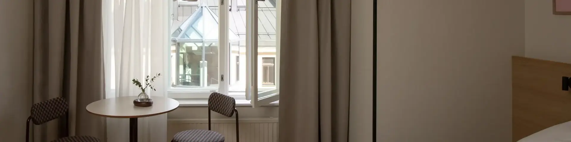 a room with a bed and chairs and a table