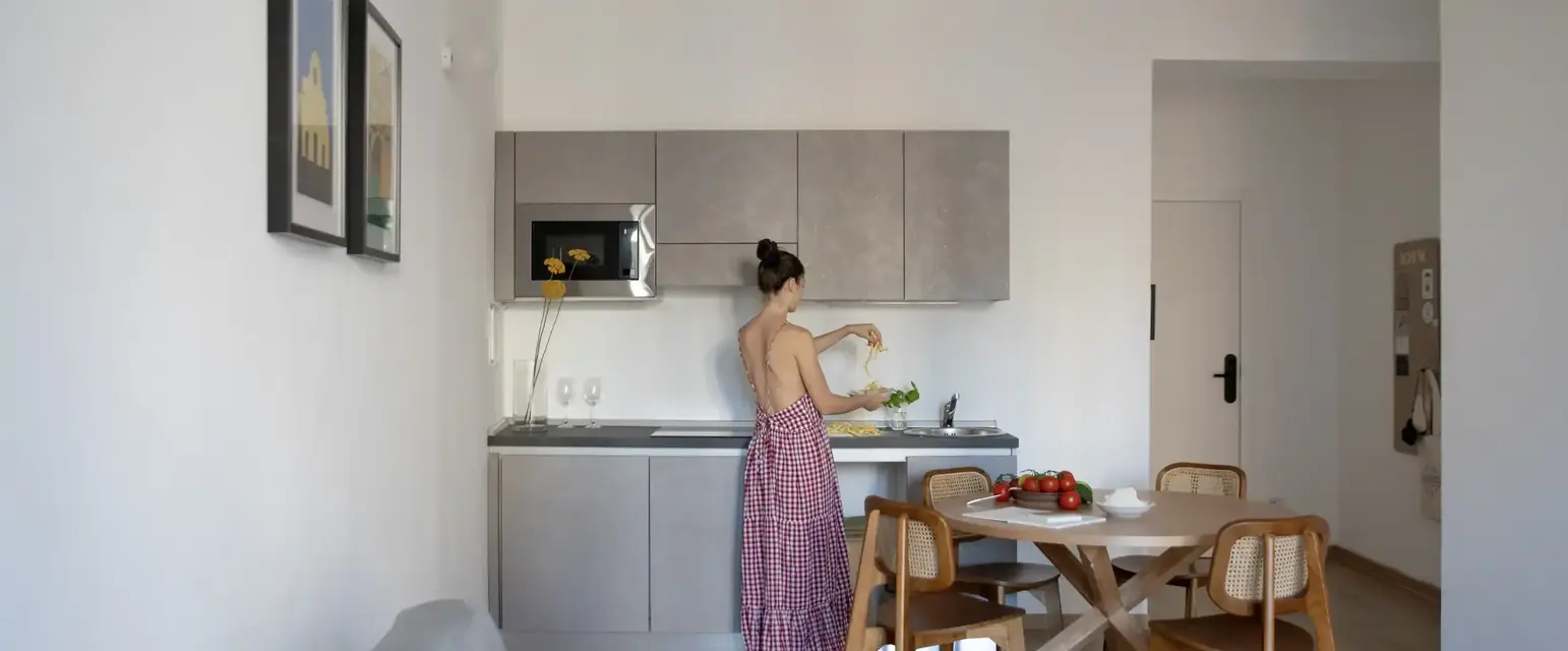 a woman in a red dress in a kitchen