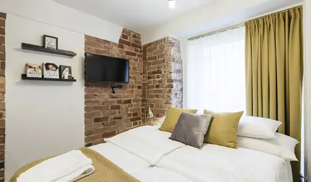 a bed with a tv on the wall