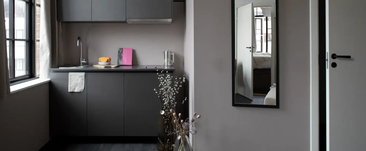 a room with a sink and a mirror