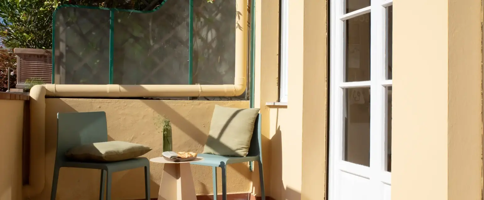 a patio with chairs and a table