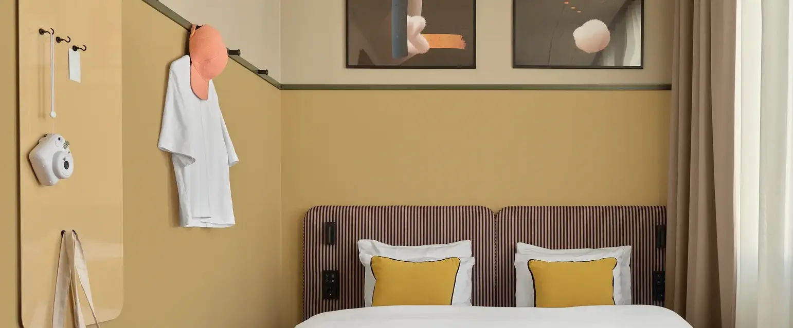 a bed with pillows and a bench in a room