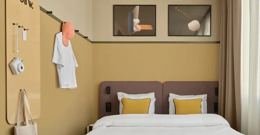 a bed with pillows and a bench in a room