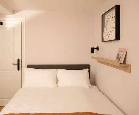 a bed with pillows and a door