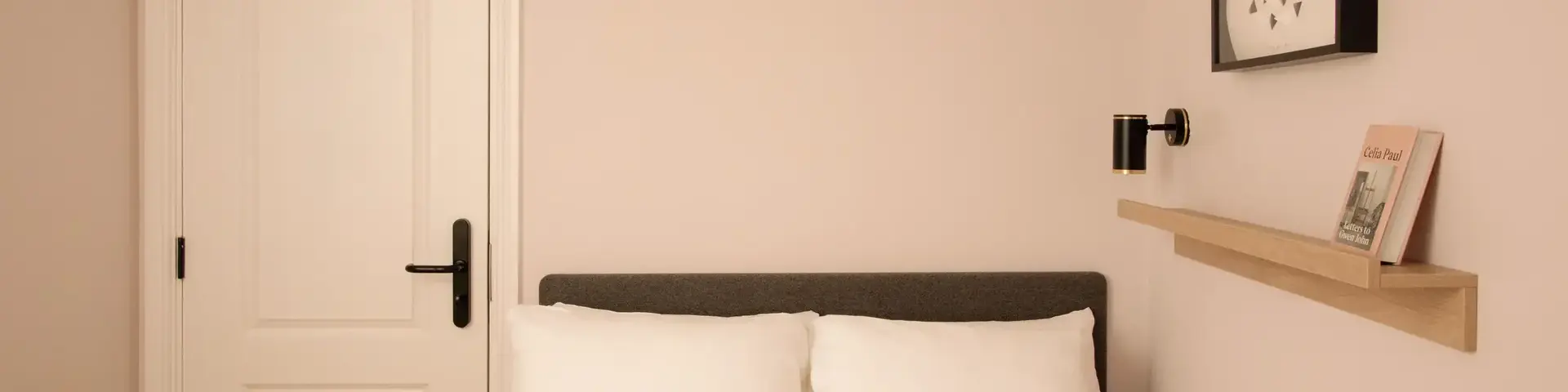 a bed with pillows and a door