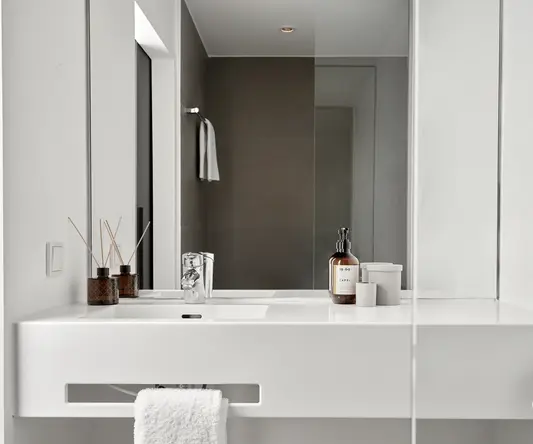 a bathroom with a mirror and a sink