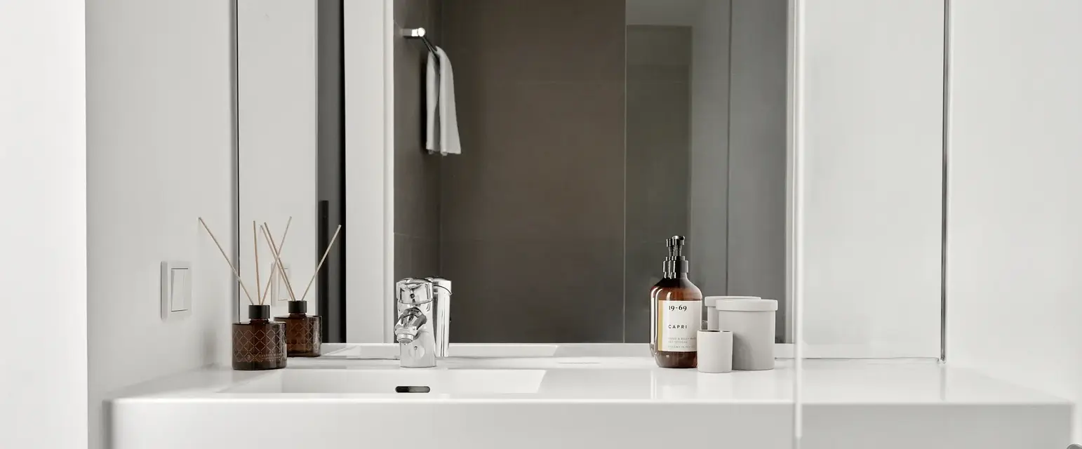 a bathroom with a mirror and a sink