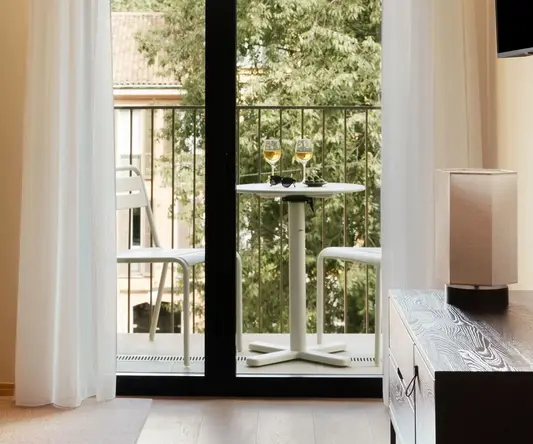 a glass door with a table and chairs on it