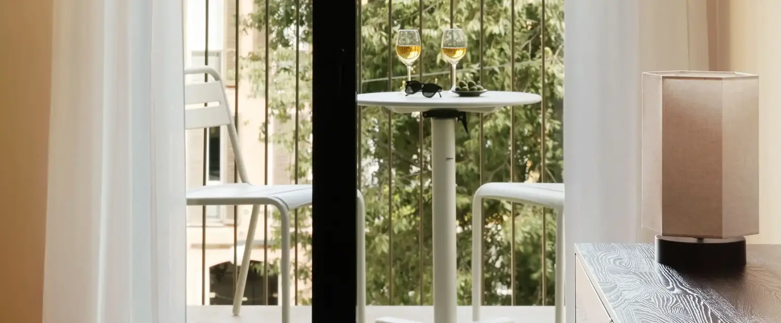 a glass door with a table and chairs on it