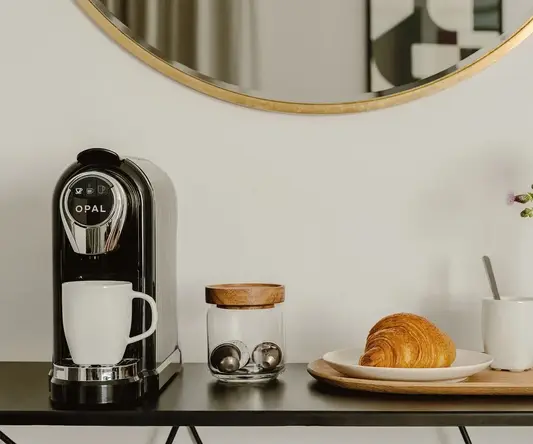 a coffee machine and croissant on a table