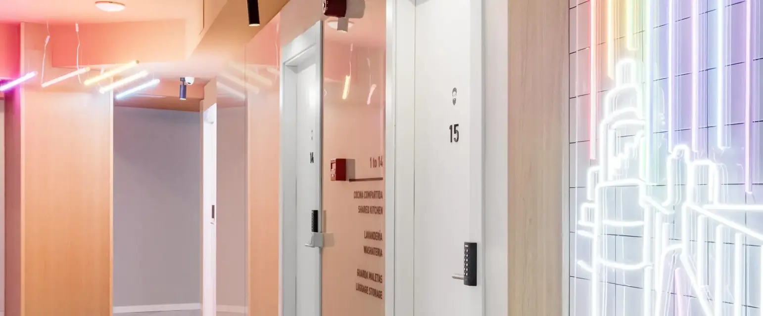 a hallway with white doors and a mirror