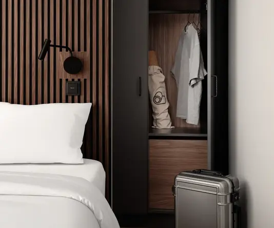 a suitcase next to a bed