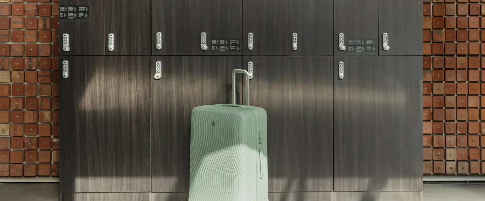 a suitcase in front of lockers