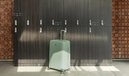 a suitcase in front of lockers