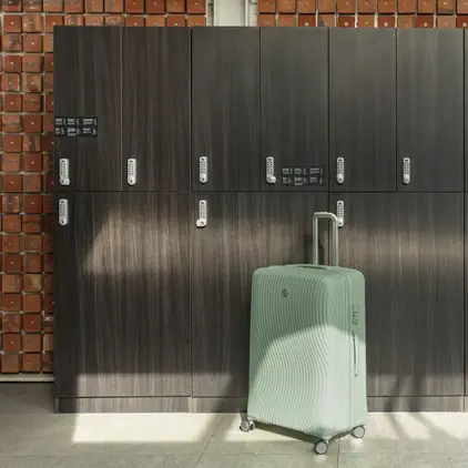 a suitcase in front of lockers