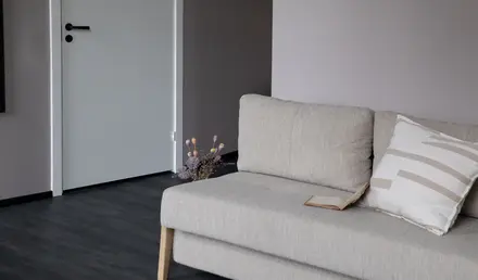 a couch with pillows and a book on it