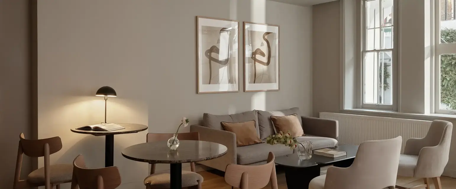 a room with a couch and chairs