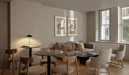 a room with a couch and chairs