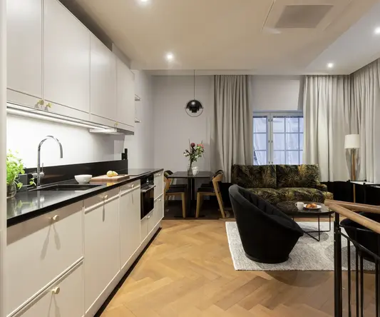 a room with a couch and kitchen