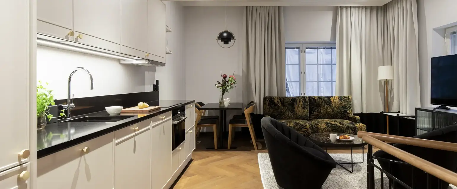 a room with a couch and kitchen