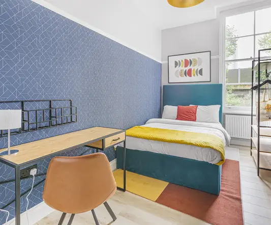 a bedroom with a bed and desk