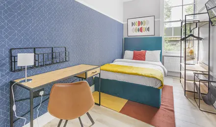 a bedroom with a bed and desk