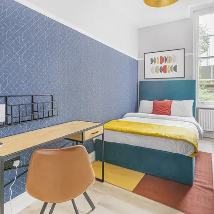 a bedroom with a bed and desk