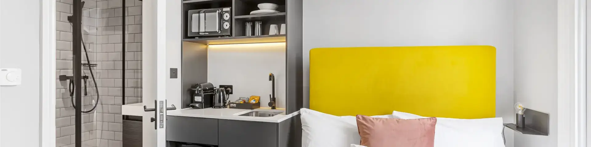 a bed with a yellow headboard in a room