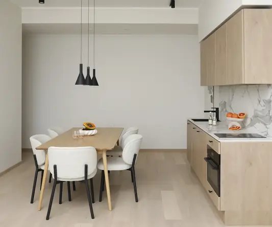 a kitchen with a table and chairs