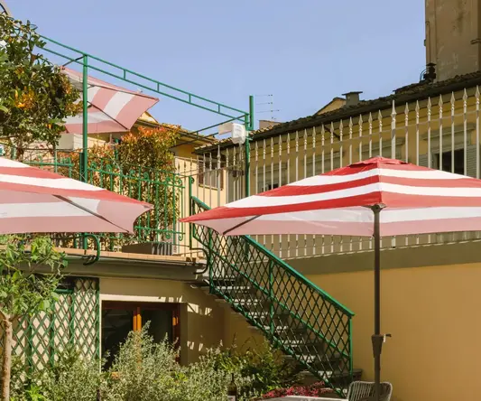 a patio with tables and umbrellas