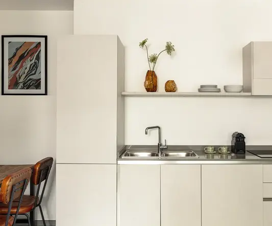 a kitchen with white cabinets and a sink