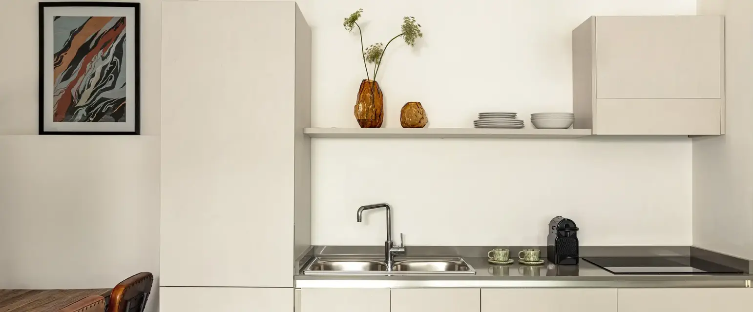 a kitchen with white cabinets and a sink