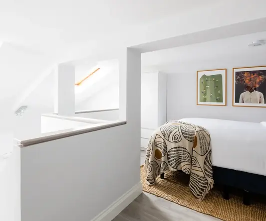 a bedroom with a bed and a rug