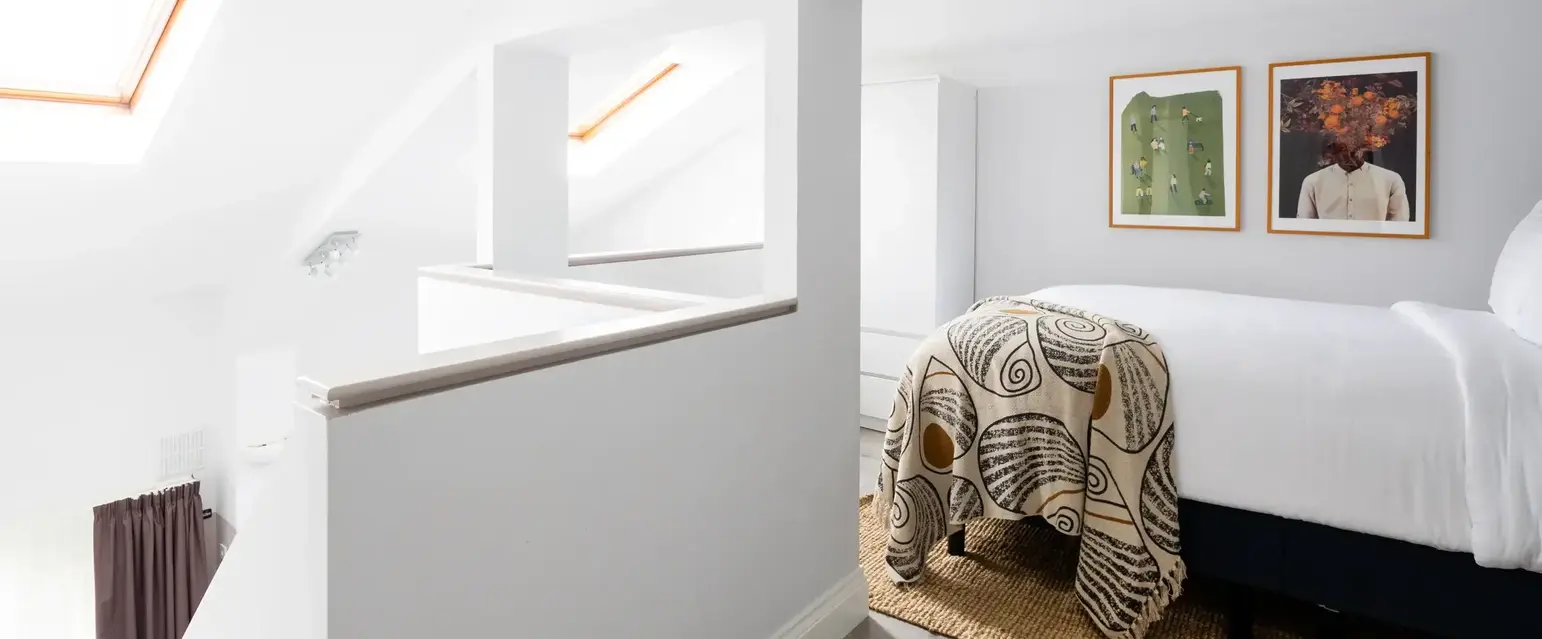 a bedroom with a bed and a rug