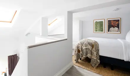 a bedroom with a bed and a rug