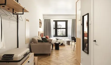 a room with a couch and a suitcase