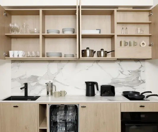 a kitchen with a counter top and shelves