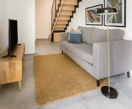 a living room with a staircase and a couch